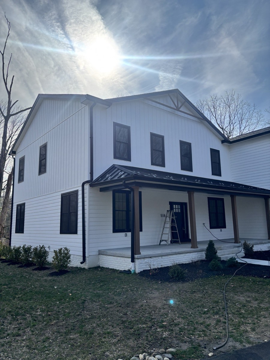Brand-new white farmhouse home with freshly detailed windows